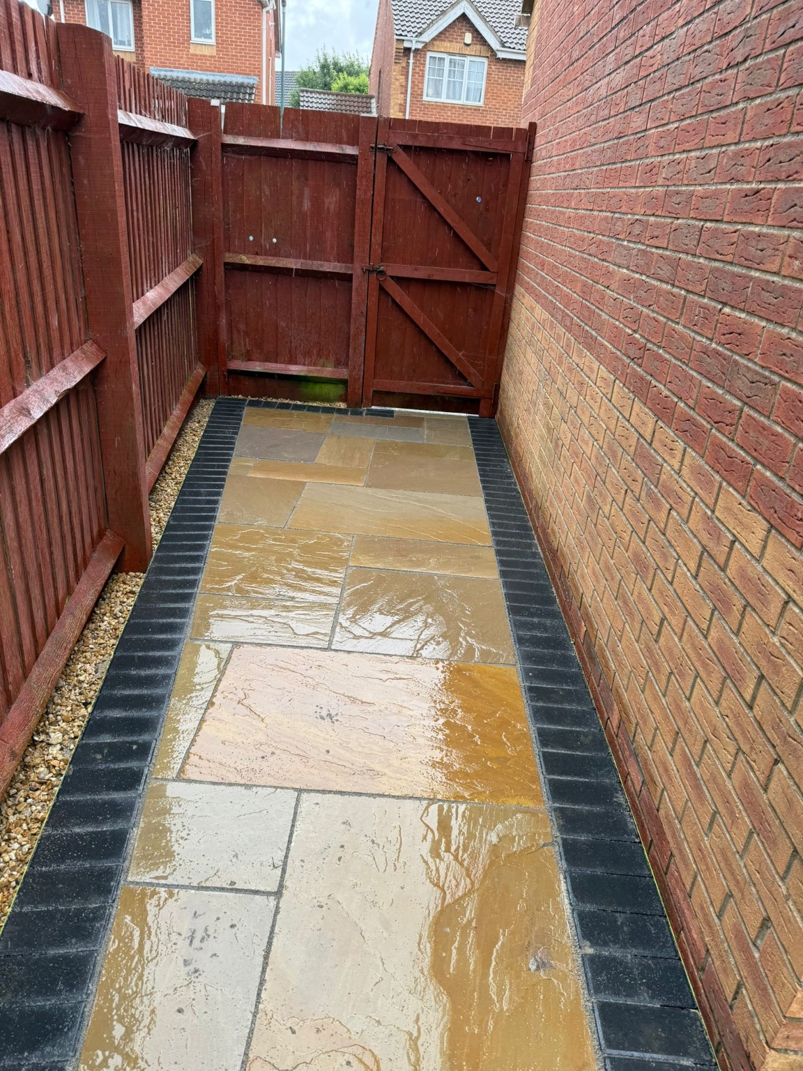 Indian sandstone side path with charcoal edging leading to the garden gate