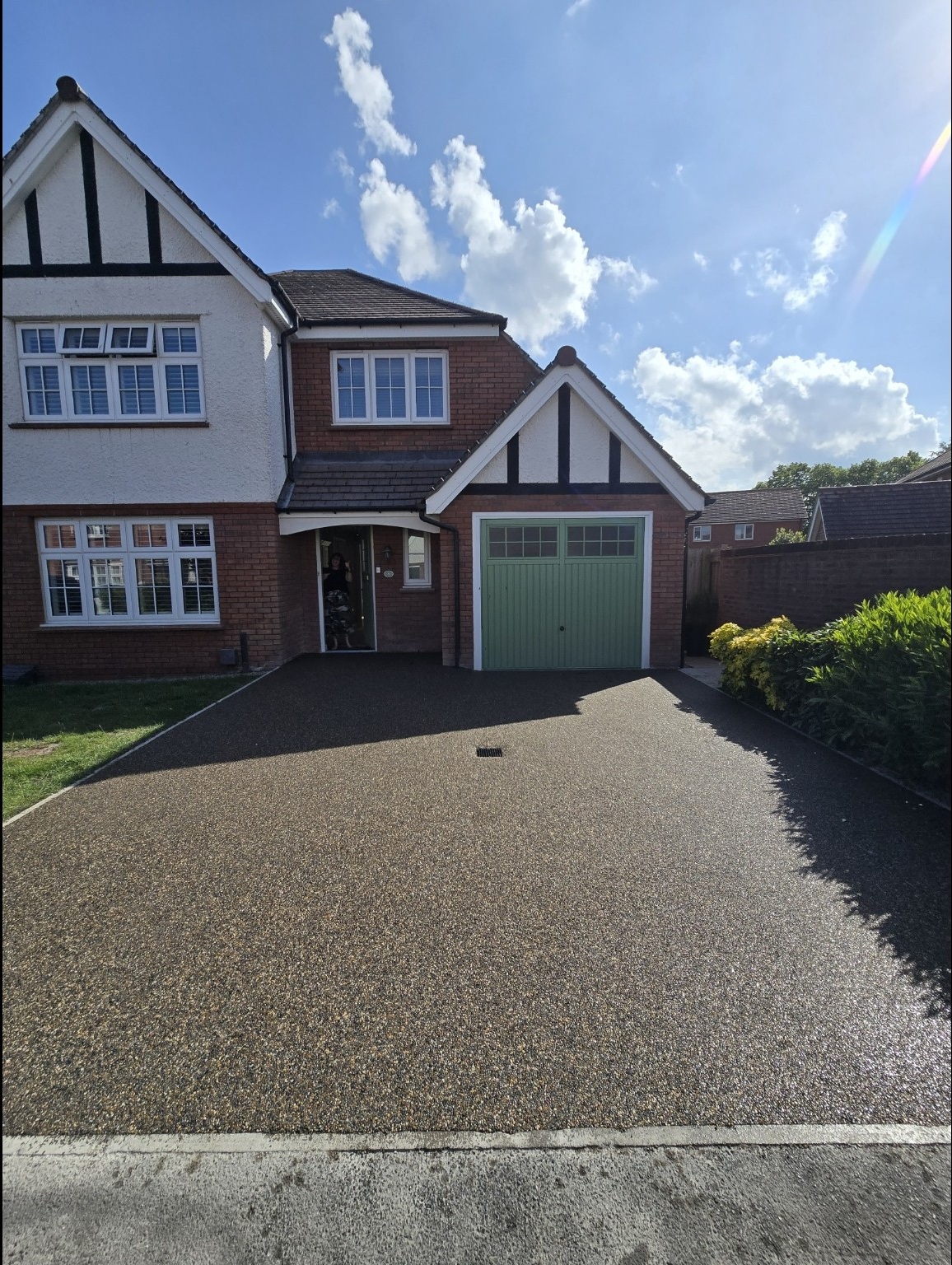 Completed Vuba Chrysler resin driveway leading to a green garage door in Bridgwater
