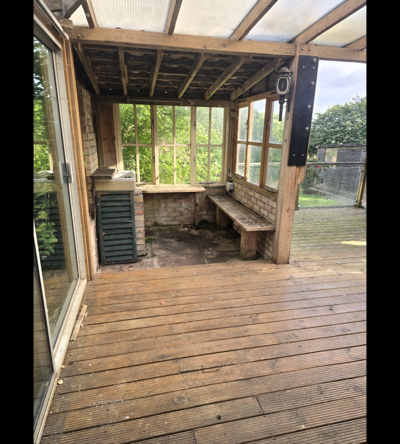 Covered timber deck and seating structure before replacement at Mr Hayman’s Taunton home