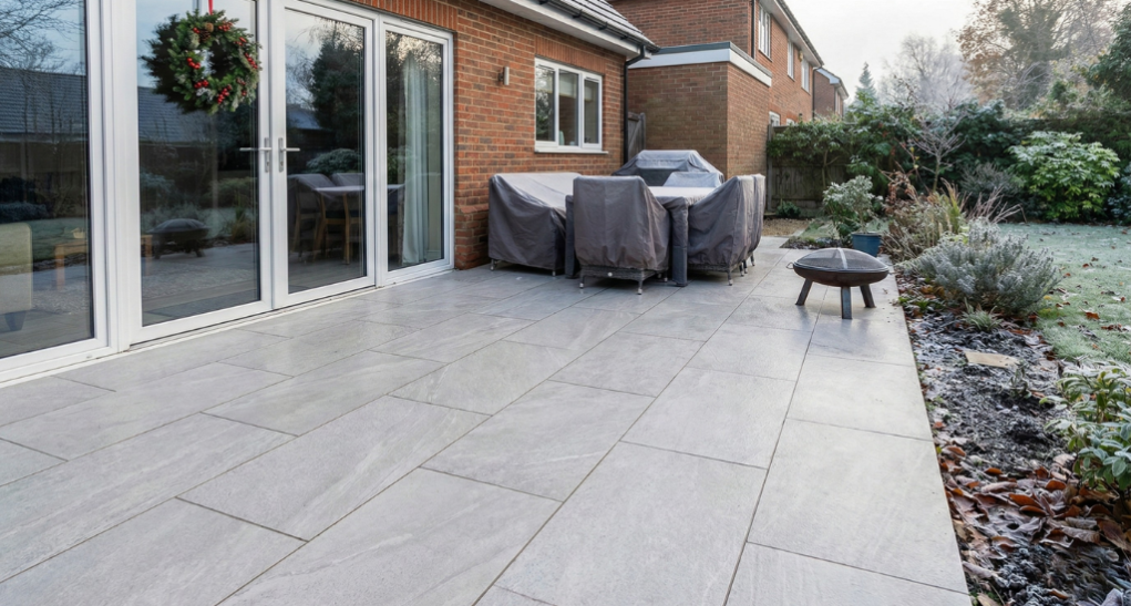 Low-absorption surfaces like porcelain perform well in winter when supported by proper groundwork and drainage.