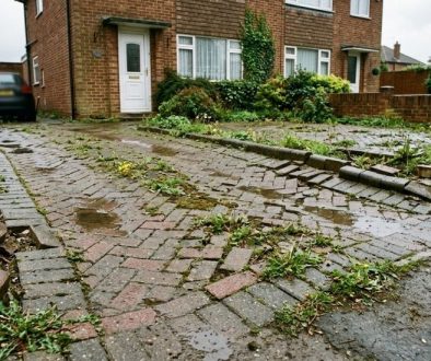 Sunken and uneven block paved driveway showing failed rogue builder workmanship in Devon